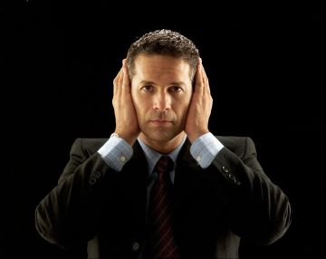 22525853 - businessman covering his ears on black background
